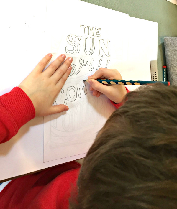 Tracing the words "the sun will come out tomorrow"
