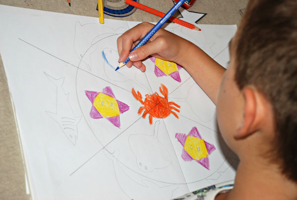 Starting to colour in his sea creature mandala