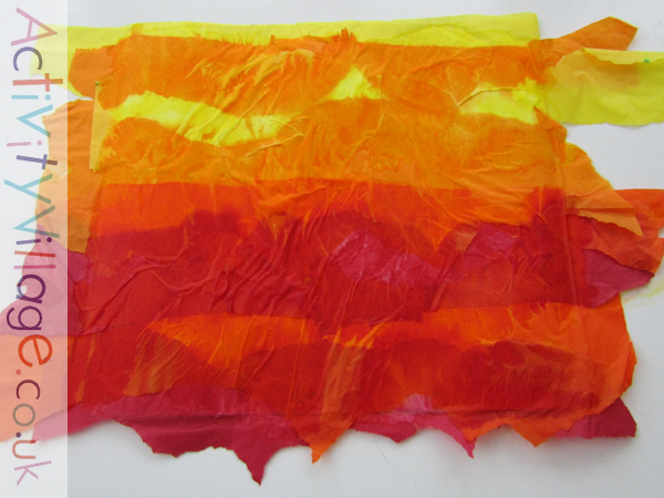 Layering strips of tissue paper over wet card