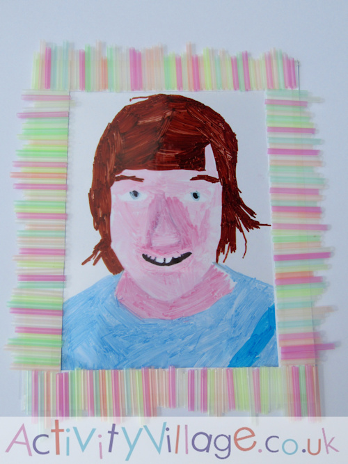 Sam's finished suncatcher self portrait, framed with his drinking straw picture frame.