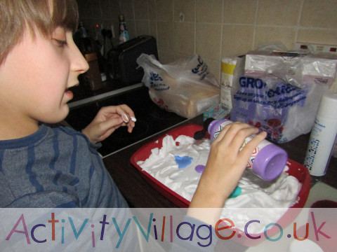 Sam squirting paint onto the shaving foam tray