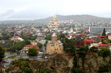 Ancient churches and modern buildings side by side in Tbilisi, capital city of Georgia