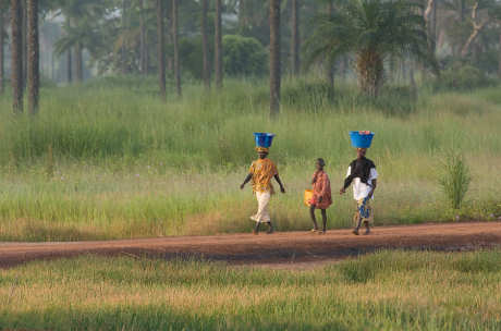Two women and a boy walking in The Gambia