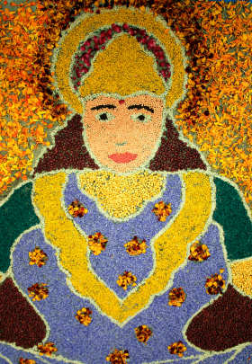 Rangoli of the goddess Lakshmi made with dal, coloured rice and dried petals