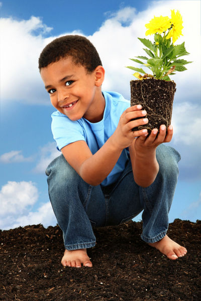 Boy planting a flower for Earth Day